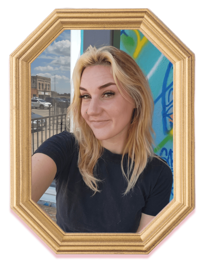 Smiling person with long blonde hair in octagonal frame, graffiti wall background.